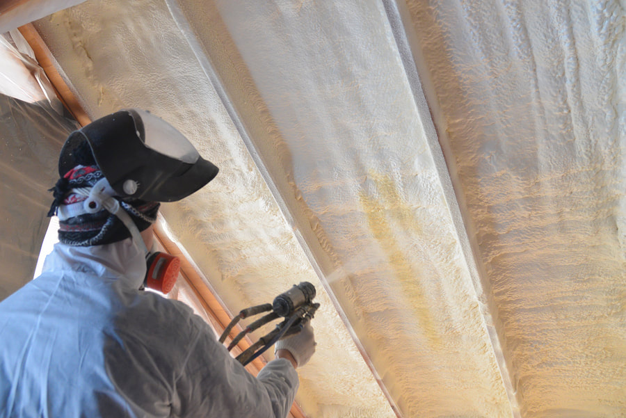 man spraying spray foam insulation
